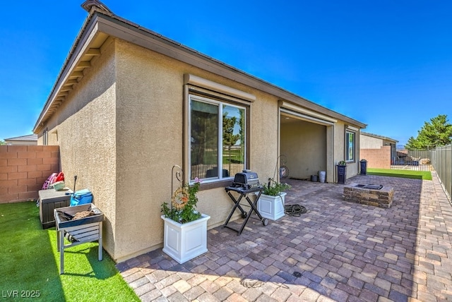 view of patio featuring a grill and an outdoor fire pit