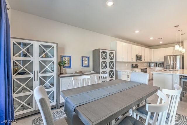 dining room featuring light tile patterned flooring and sink