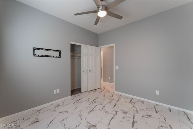 unfurnished bedroom with ceiling fan and a closet