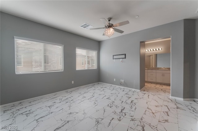 unfurnished bedroom featuring ensuite bathroom and ceiling fan