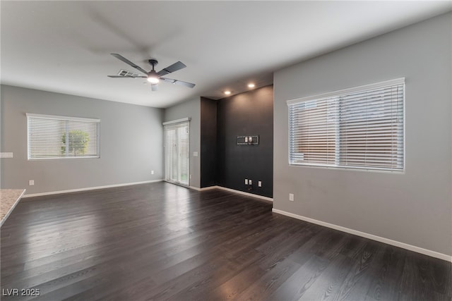 empty room featuring ceiling fan and dark hardwood / wood-style floors