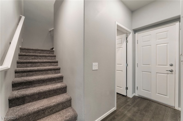 stairway with hardwood / wood-style flooring