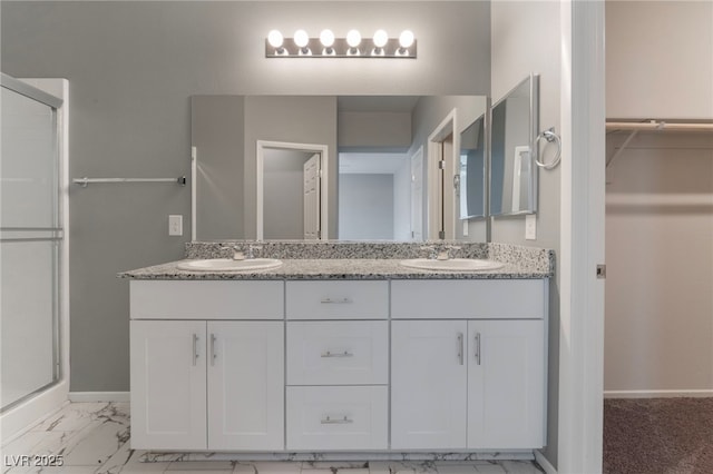 bathroom featuring an enclosed shower and vanity