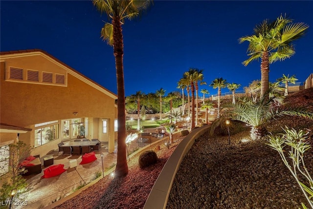 yard at twilight with a patio area