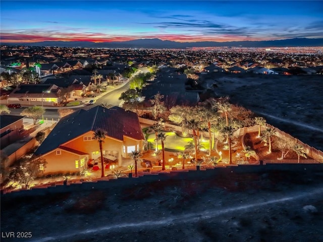 aerial view at dusk featuring a mountain view