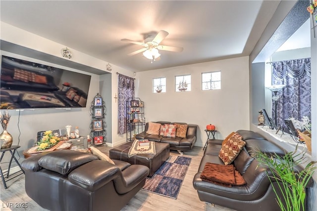 living room featuring ceiling fan and light wood-type flooring