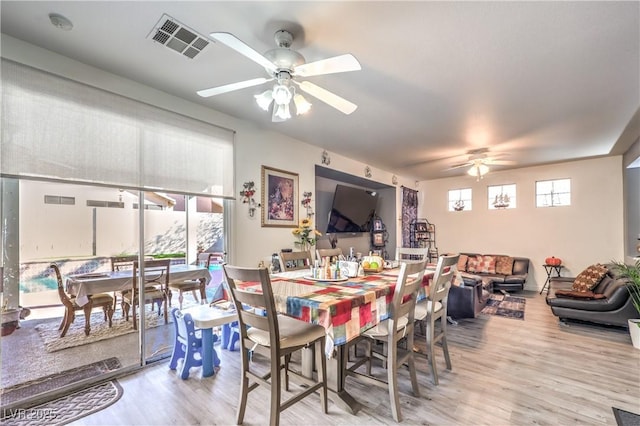 dining area featuring light hardwood / wood-style flooring and ceiling fan