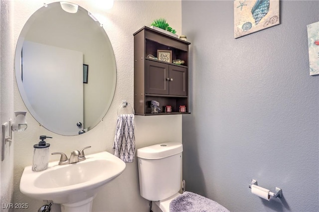 bathroom with toilet and sink