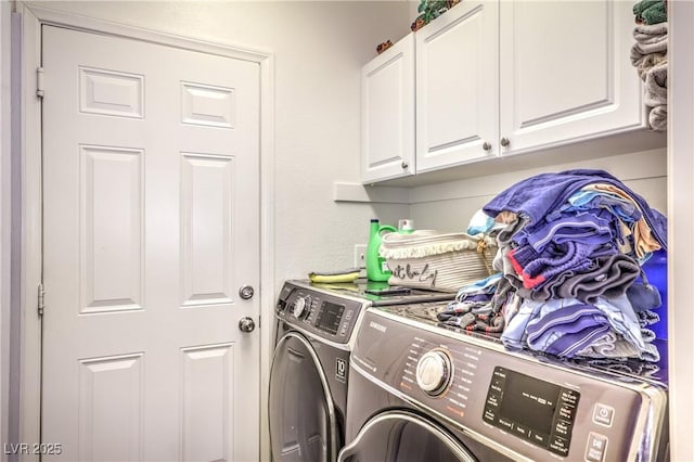 laundry room featuring cabinets and washer and dryer