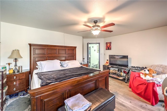 bedroom with light hardwood / wood-style floors and ceiling fan