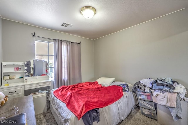 carpeted bedroom featuring a textured ceiling