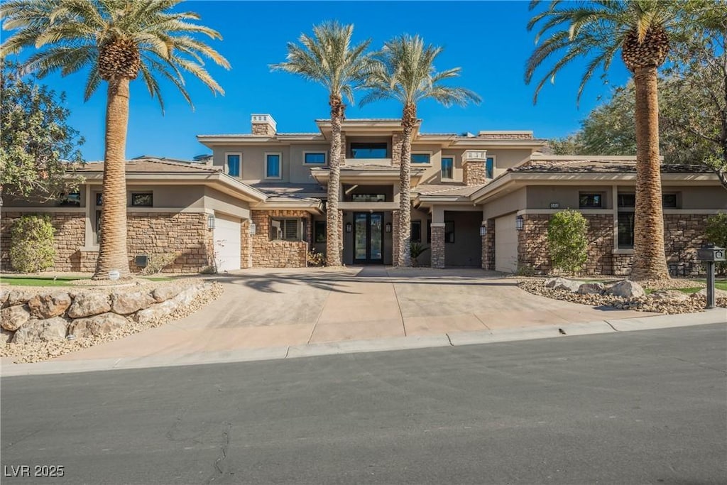 646 Saint Croix St, Henderson, NV 89012 - prairie-style house with concrete driveway, an attached garage, stone siding, and stucco siding