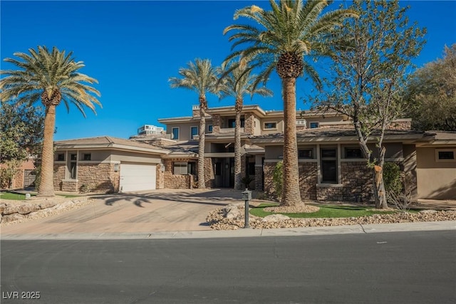 view of front of home featuring stone siding, stucco siding, driveway, and a garage