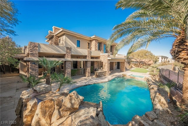 outdoor pool with a patio area and fence