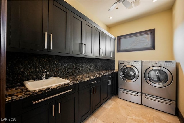 clothes washing area with cabinet space, washer and dryer, a ceiling fan, and a sink