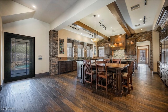 dining space with visible vents, lofted ceiling with beams, baseboards, and dark wood-style flooring