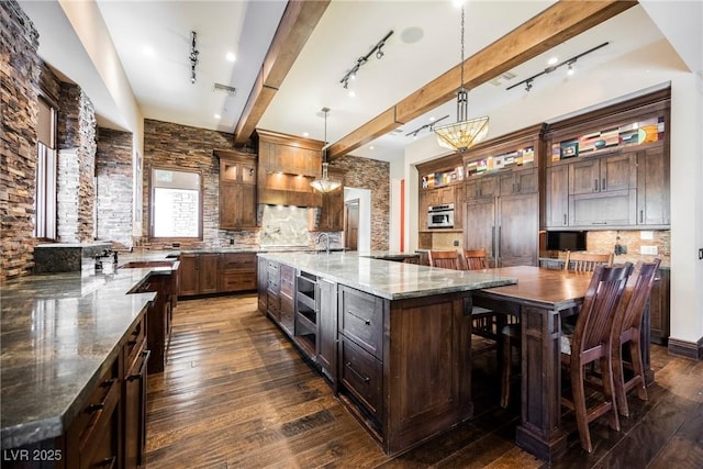 kitchen featuring visible vents, glass insert cabinets, dark wood finished floors, beamed ceiling, and decorative backsplash