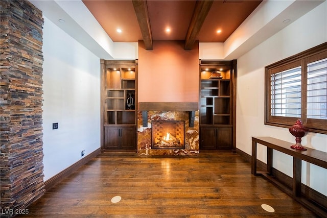 living area with hardwood / wood-style flooring, a fireplace, and baseboards