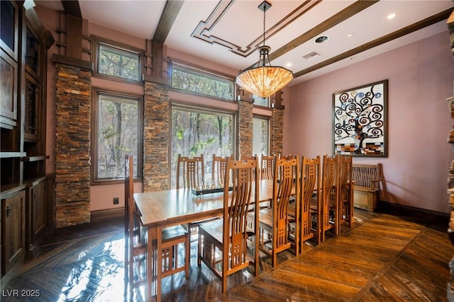 dining room with beamed ceiling and baseboards