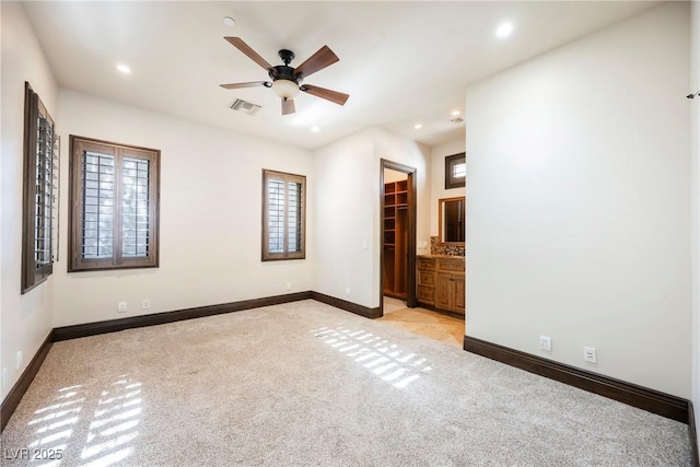 unfurnished bedroom featuring visible vents, light carpet, a ceiling fan, recessed lighting, and baseboards