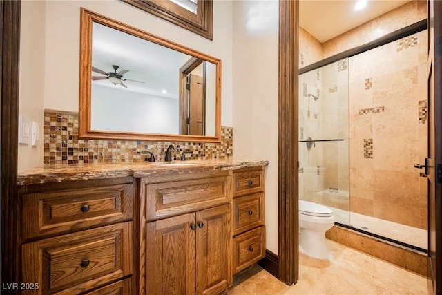 bathroom featuring decorative backsplash, a shower stall, toilet, and vanity