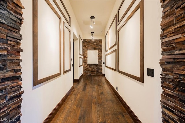 hall with baseboards and dark wood-style flooring