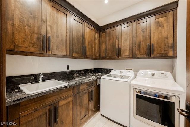 laundry room featuring a sink, cabinet space, and washing machine and clothes dryer