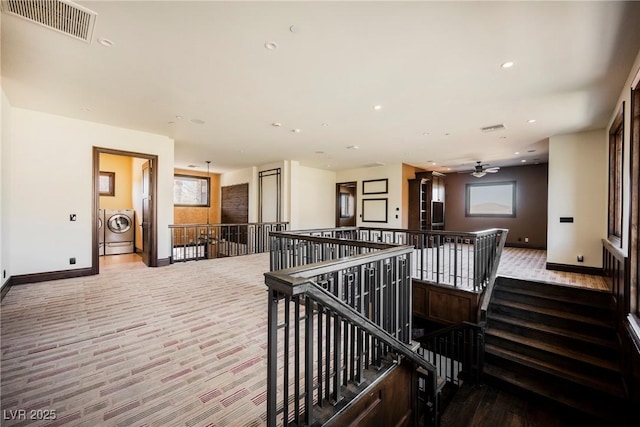 hallway featuring visible vents, baseboards, washer / clothes dryer, recessed lighting, and an upstairs landing