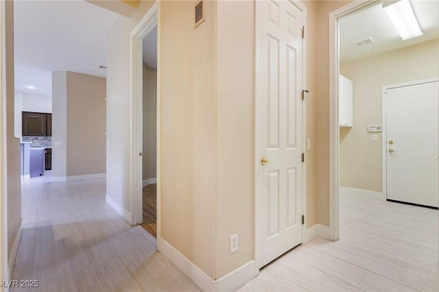 corridor with light wood-type flooring