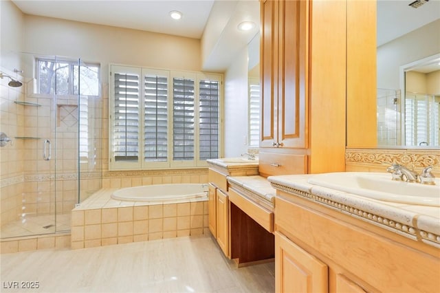 bathroom with vanity and independent shower and bath