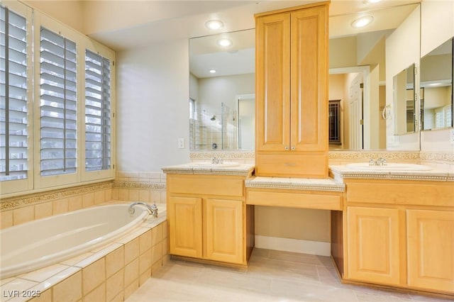 bathroom with vanity, tile patterned flooring, and shower with separate bathtub