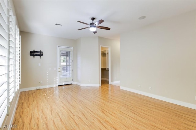 empty room with light hardwood / wood-style flooring and ceiling fan