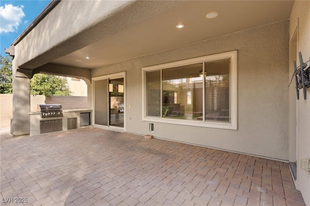 view of patio featuring exterior kitchen and grilling area