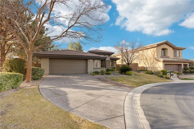 view of front of home with a garage and a front lawn