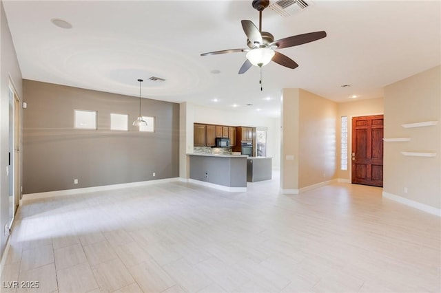 unfurnished living room with ceiling fan