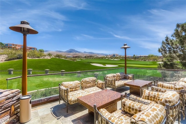 view of patio featuring a balcony, an outdoor hangout area, and a mountain view