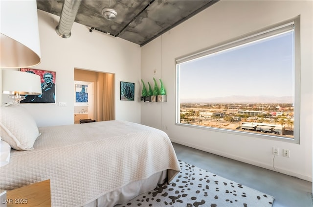 bedroom featuring concrete flooring