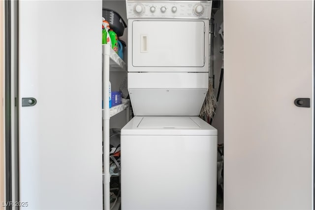 washroom featuring stacked washer and dryer