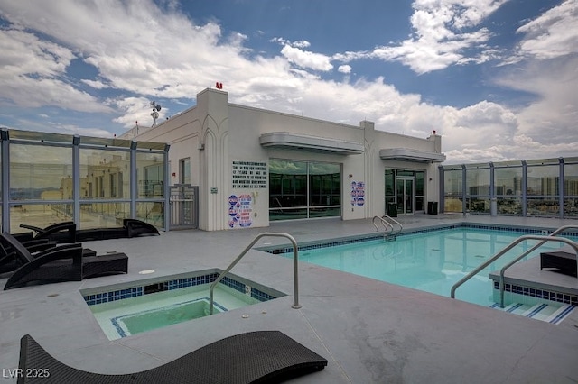 view of pool featuring a hot tub and a patio