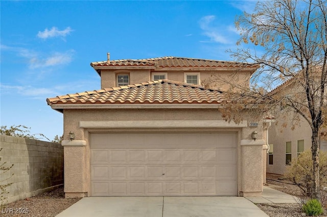 mediterranean / spanish-style house with a garage