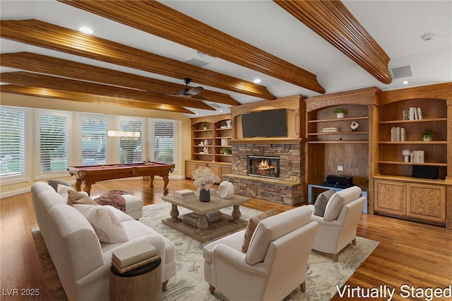 living room featuring beamed ceiling, a healthy amount of sunlight, pool table, and light hardwood / wood-style flooring