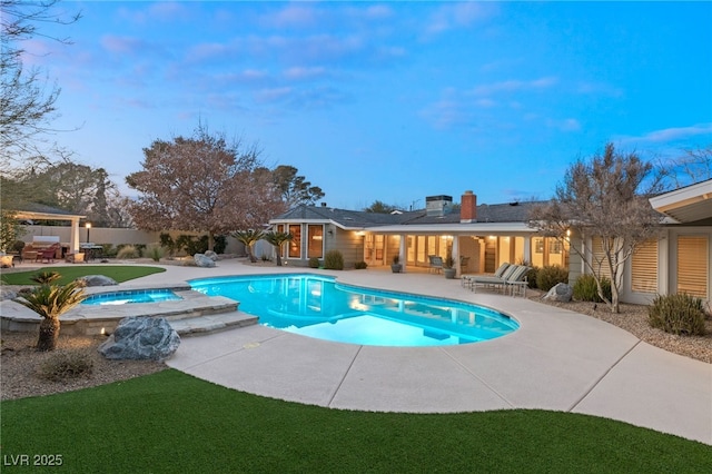 view of swimming pool with a patio area and an in ground hot tub