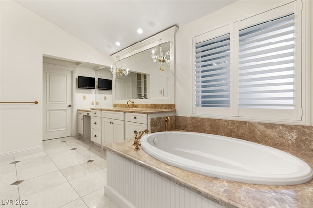 bathroom with tile patterned floors, vanity, vaulted ceiling, and a washtub