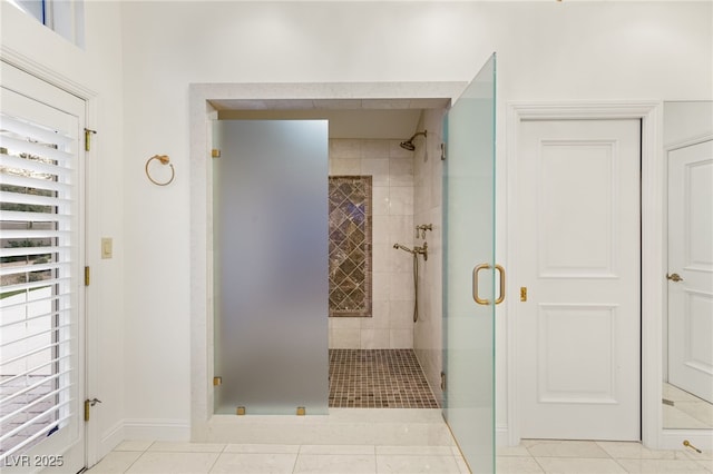 bathroom featuring tile patterned floors and a shower with door