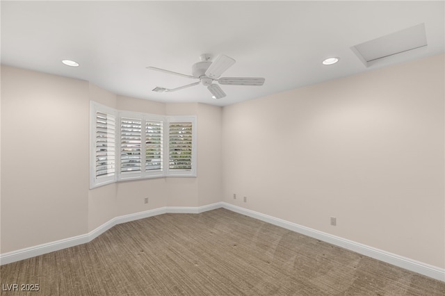 carpeted spare room featuring ceiling fan