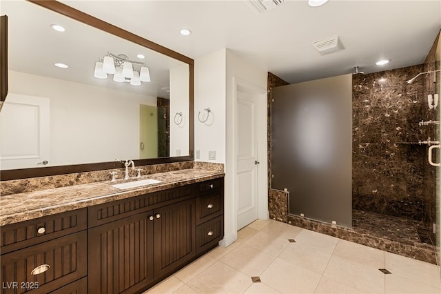 bathroom with vanity, an enclosed shower, and tile patterned flooring