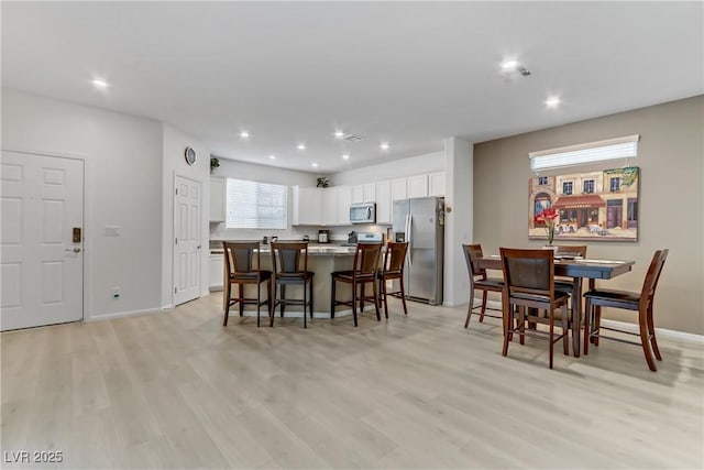 dining area with light wood-type flooring