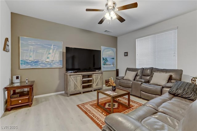 living room featuring light hardwood / wood-style floors and ceiling fan