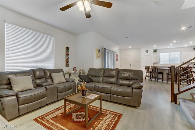 living room with ceiling fan and light hardwood / wood-style floors