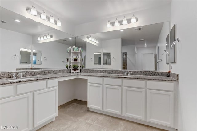 bathroom with vanity and a shower with door